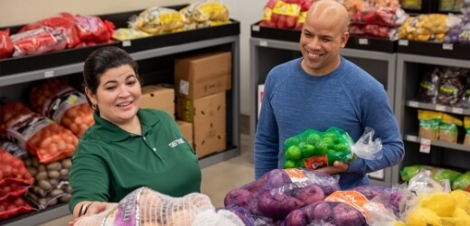 Employee helping a customer with produce