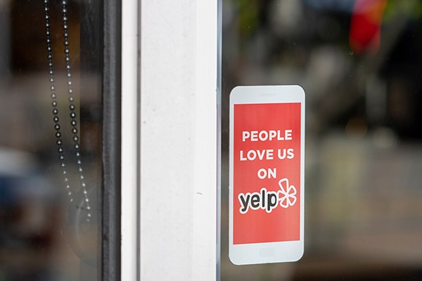 yelp review sticker on restaurant window.