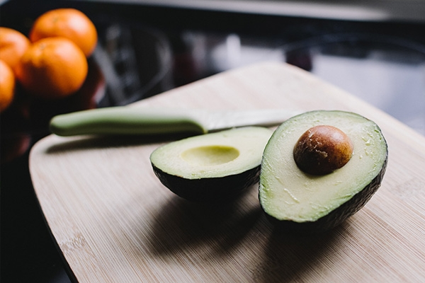 two avocados on a cutting board