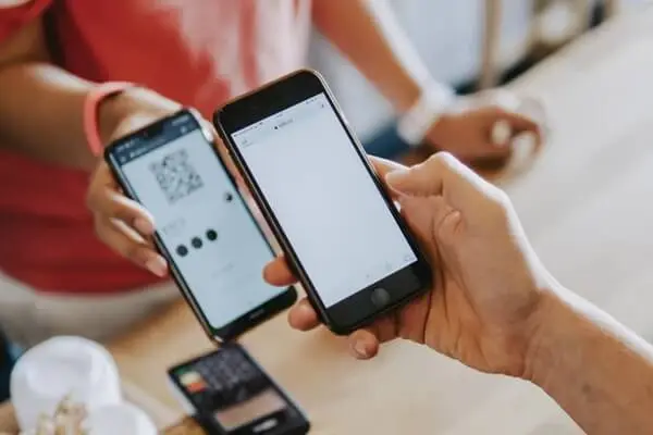 Person scanning a QR code on a phone.