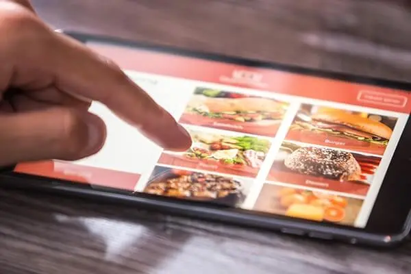 pointing to smart tablet with menu.