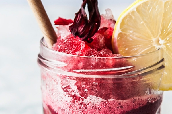 Berry mixed drink with lemon slice.