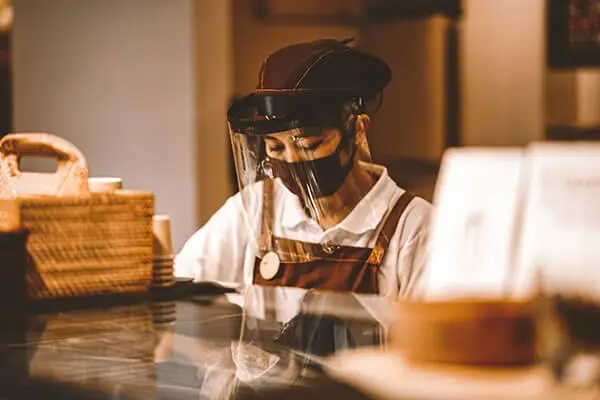 Woman in face mask behind counter