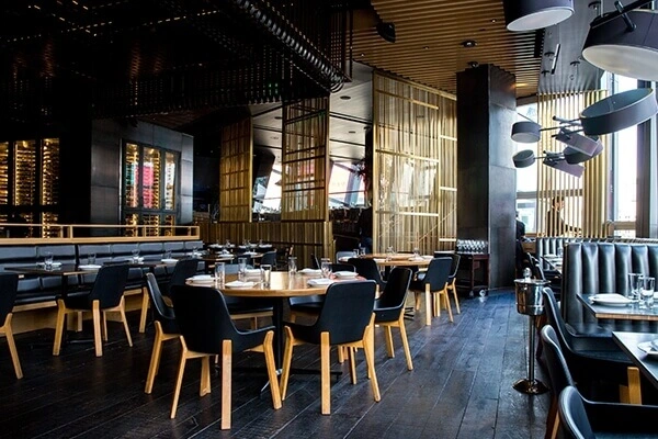 Dining tables and seating in modern restaurant.