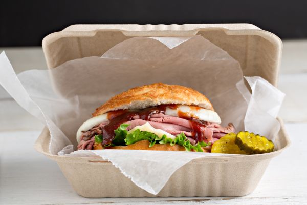 A burger in a takeout container.