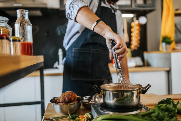 Chef making soup with fall ingredients.