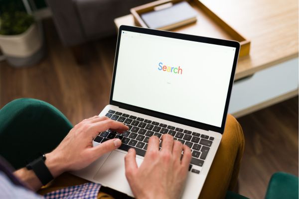 hands typing on laptop keyboard