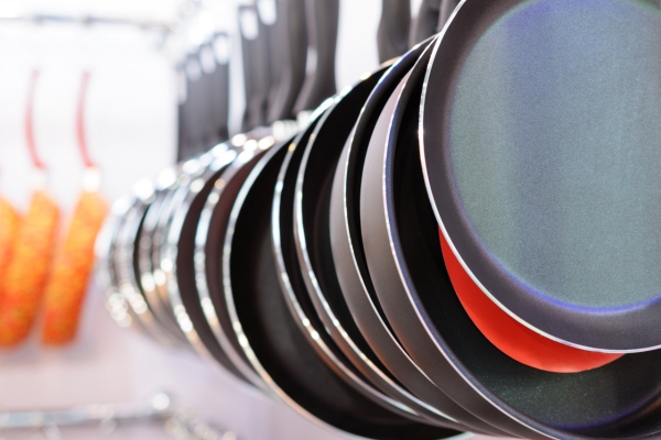 different types of pans above kitchen sink.