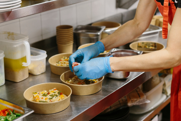 Woman pointing to a menu while talking to a server.