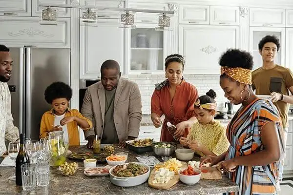 Family preparing dinner at the kitchen counter.