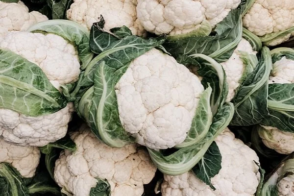Pile of whole cauliflower.