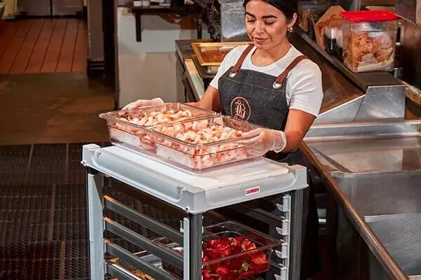 employee sorting food that will be prepared for restaurant.