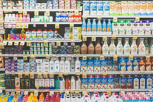 Grocery store dairy aisle of milk and yogurt.