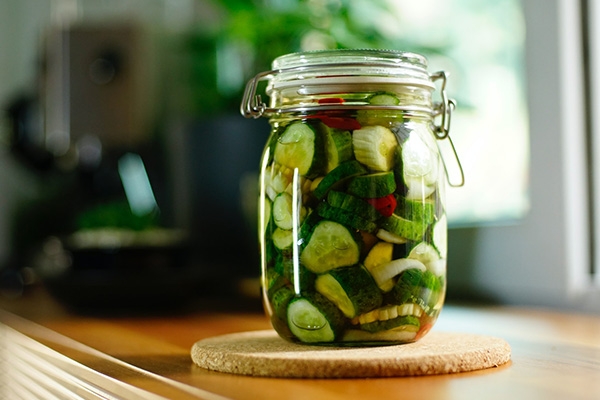 Clip top glass jar filled with pickels.