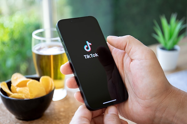 tiktok user on phone at a restaurant