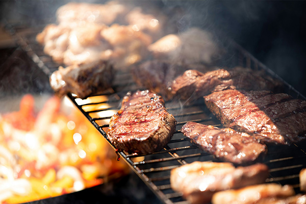 Meat cooking on a wood pellet grill.