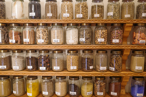 rack of spices on shelf.