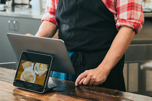 restaurant worker looking at pos system in restaurant
