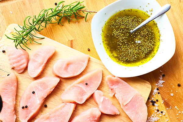 marinade in bowl next to raw meat.