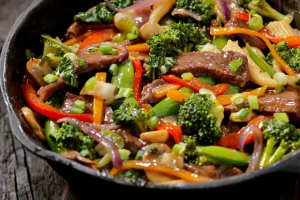 Beef stir fry in a cast iron skillet.