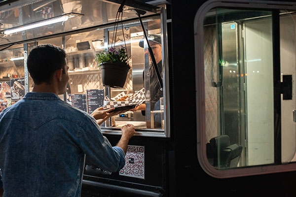 Man ordering at a food truck.