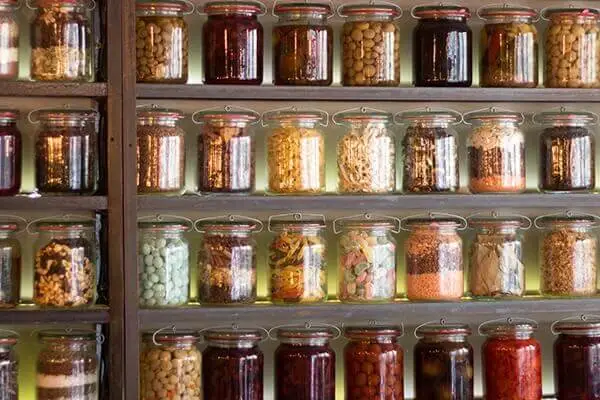 Jars of food and spices on shelves.