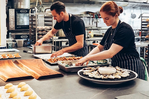 chefs preparing food in the kitchen