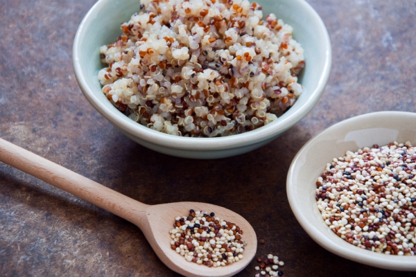 two bowls of quinoa with spoon on side.