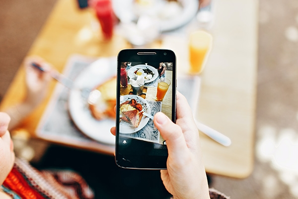 person taking a photo of their food