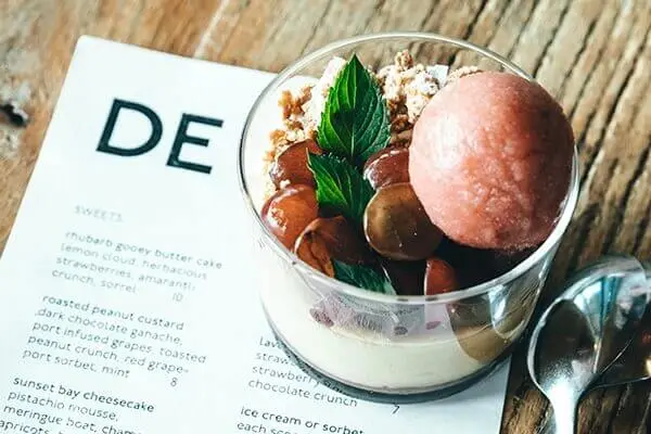 fancy food in a glass bowl  on top of a dessert menu