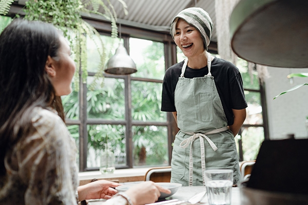 waitress taking order from customer.