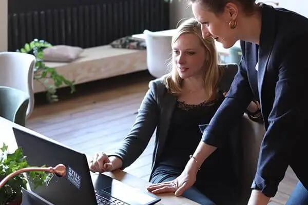 Two women looking at a laptop